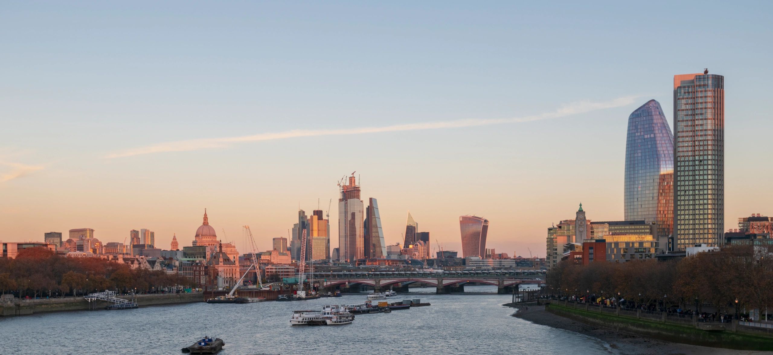 Wide shot of London skyline at twilight