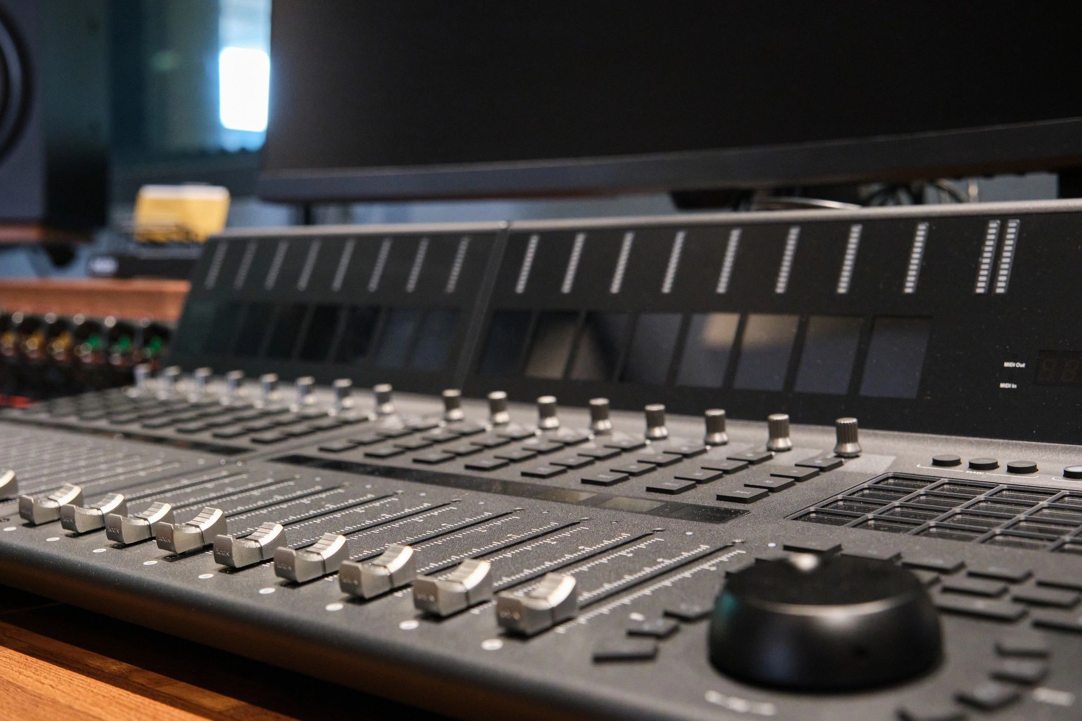 Close-up of audio mixer faders and controls