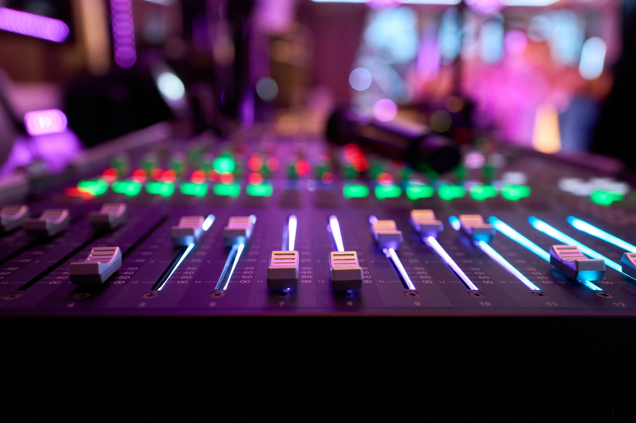 Audio mixing console with illuminated controls