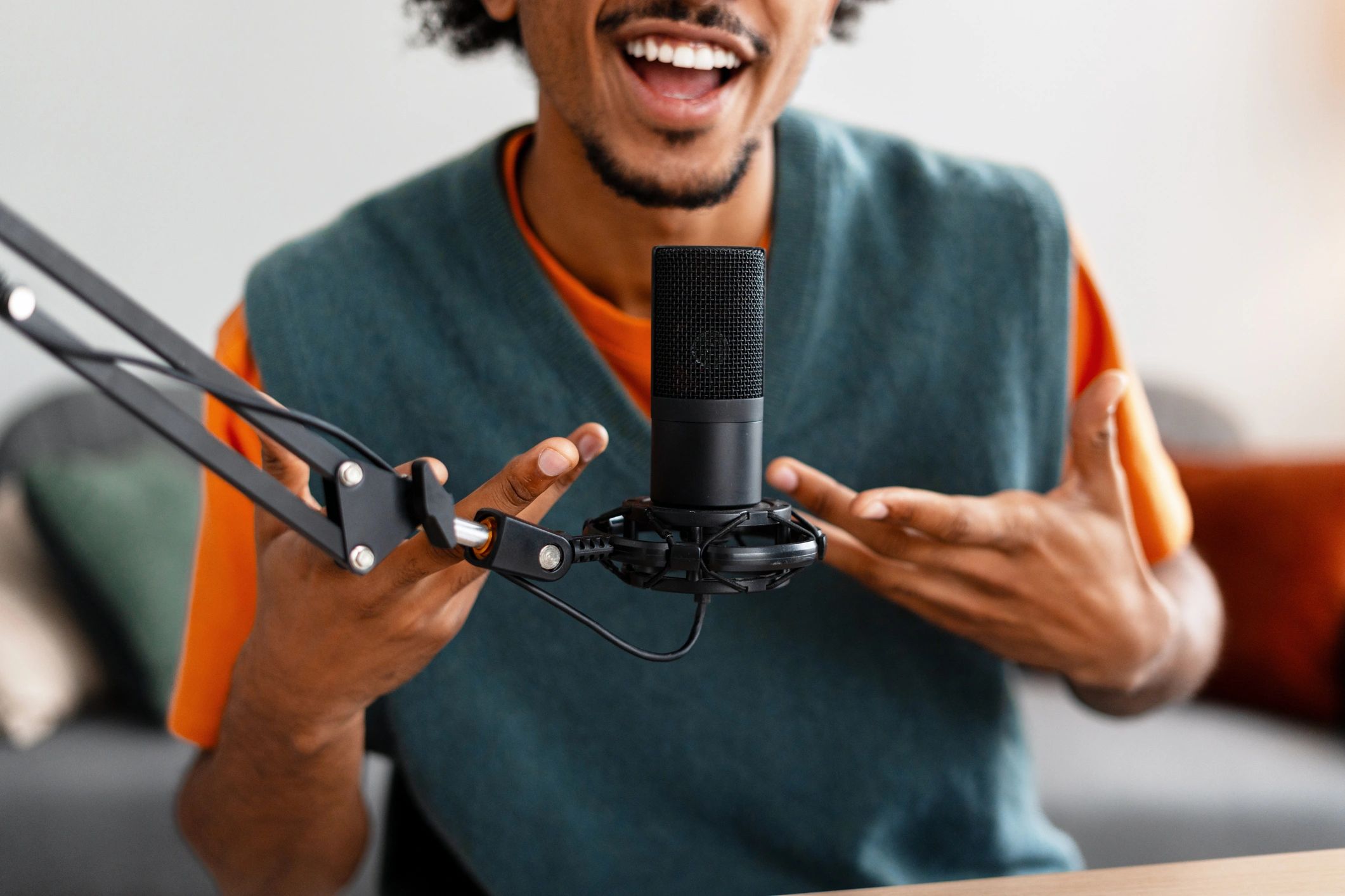 Podcaster presenting and gesturing while recording