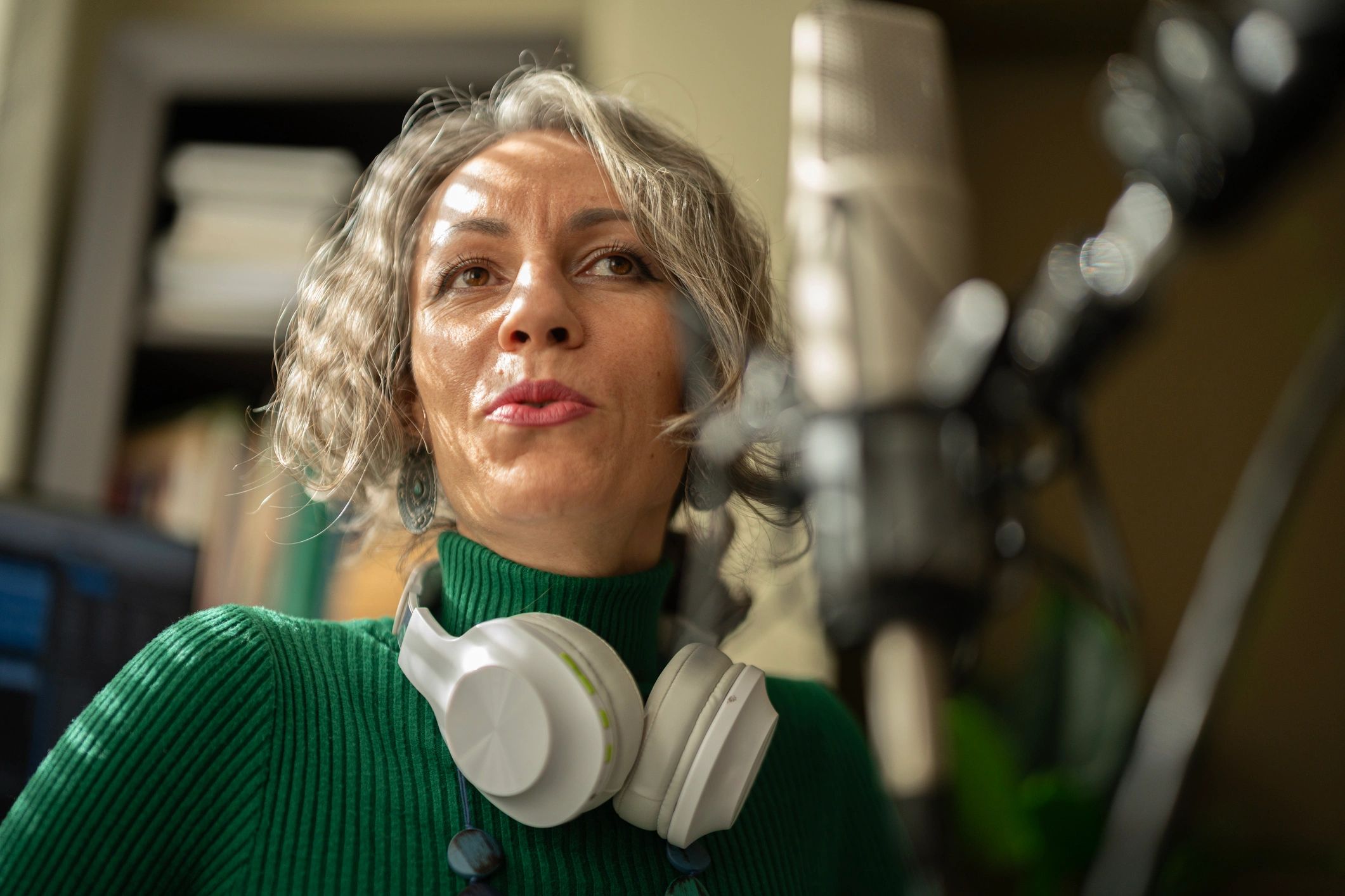 Presenter in a studio setting speaking into a microphone