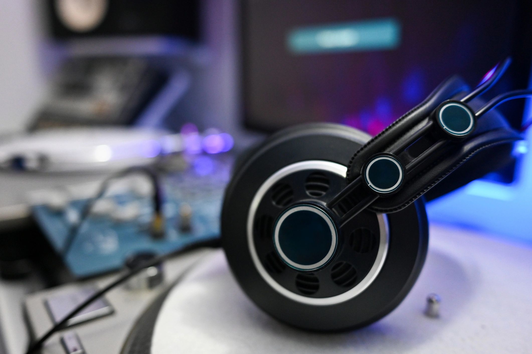 Headphones resting on audio equipment in a studio