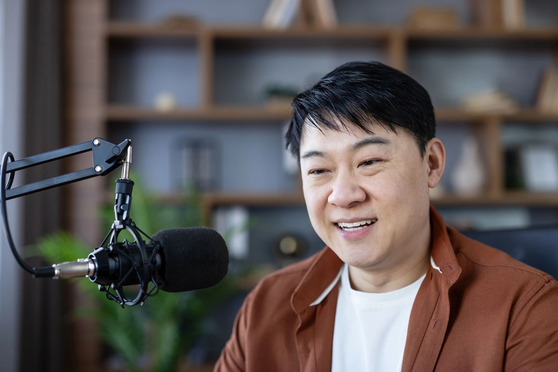Presenter recording audio in a modern studio
