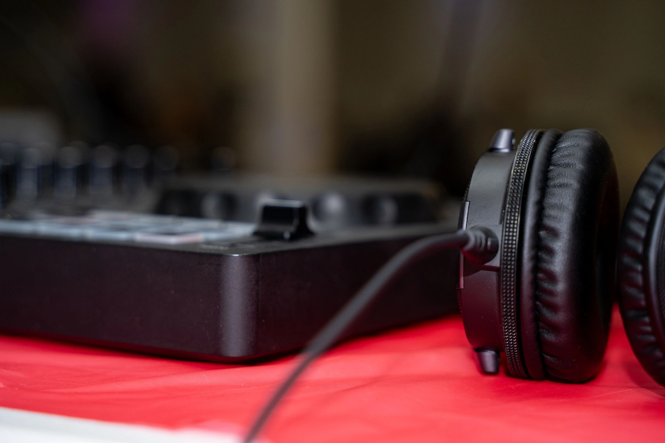 Headphones resting on a DJ table setup